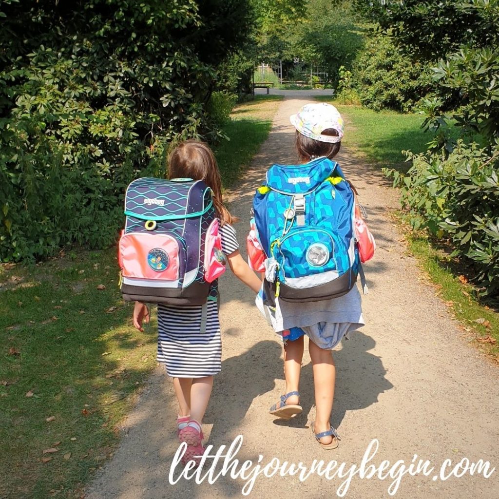 Two girls walking from school with Schulranzen backpacks